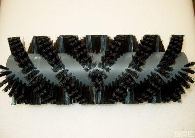 Brosse rotative d'évacuation de produits en vis d'Archimède